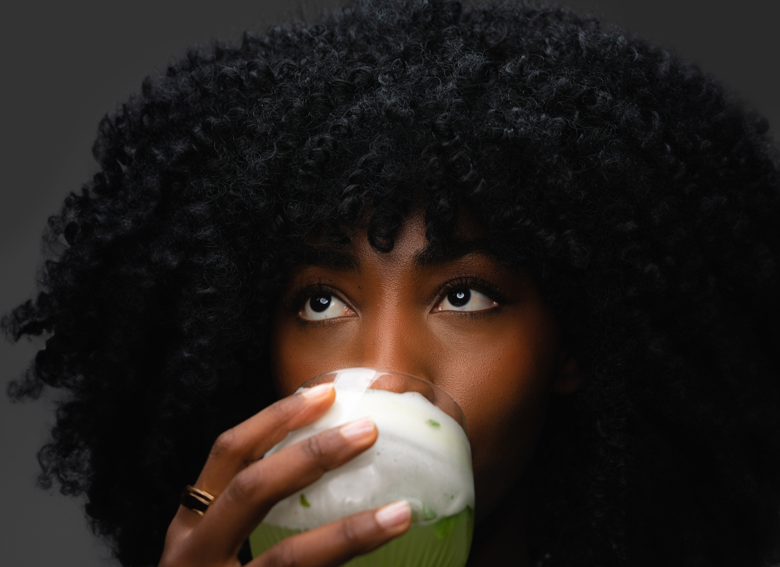 A woman drinking from a glass